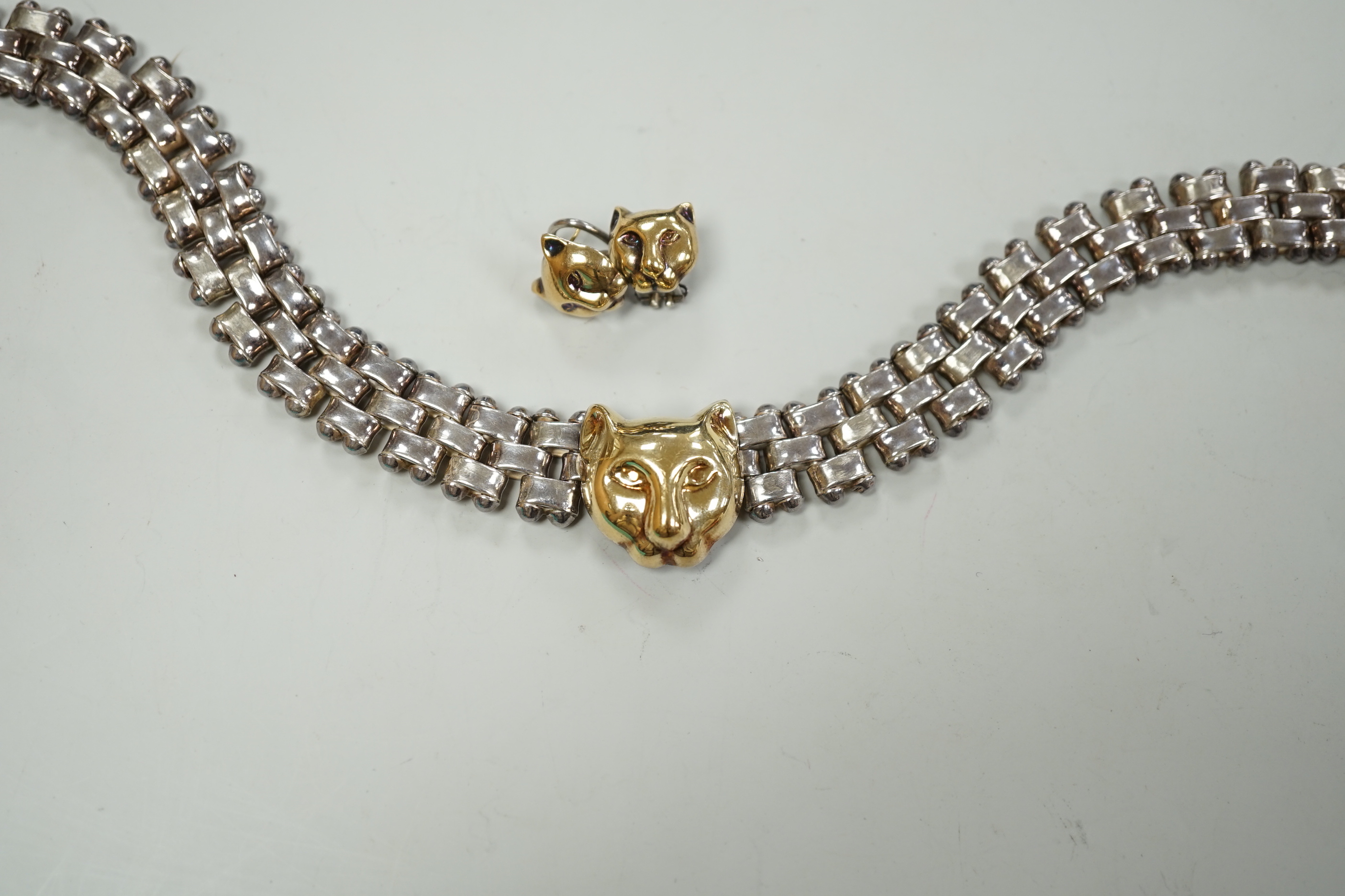 A modern Italian silver and 750 yellow metal necklace and pair of matching earrings, with leopard's head motif, necklace, 40cm.